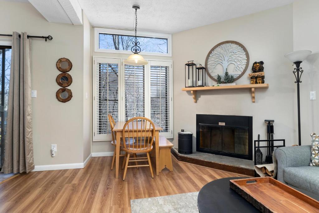 a living room with a table and a fireplace at Laurelwood 84 with Wintergreen Advantage in Wintergreen