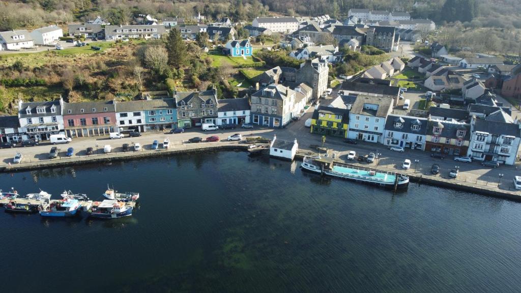 an aerial view of a harbor with boats in the water at The waterfront in Tarbert