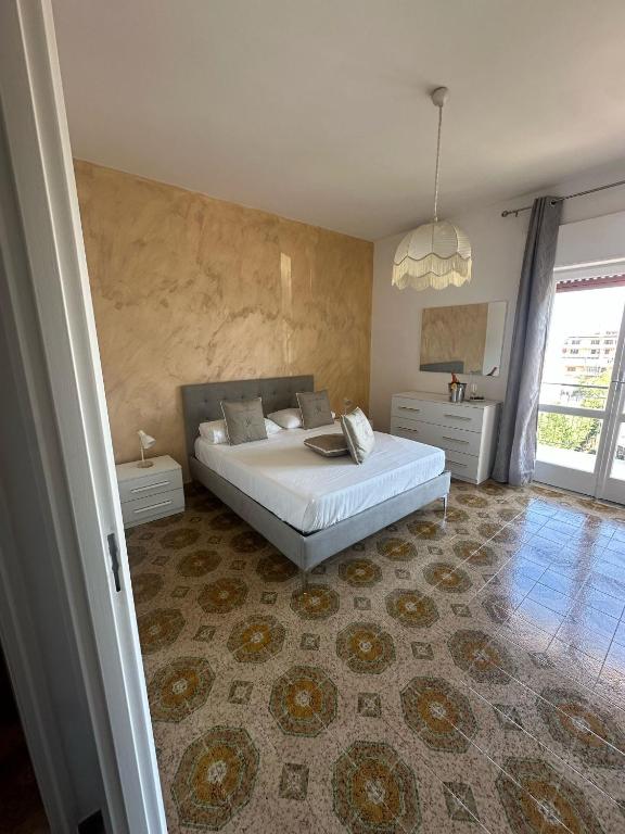 a bedroom with a large white bed in a room at Greta Apartment Tropea in Tropea