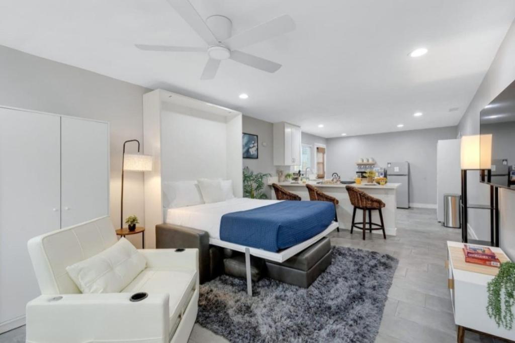 a bedroom with a bed and a living room at Studio 2 Pool Spa Min to Downtown Freeways Beaches in San Diego