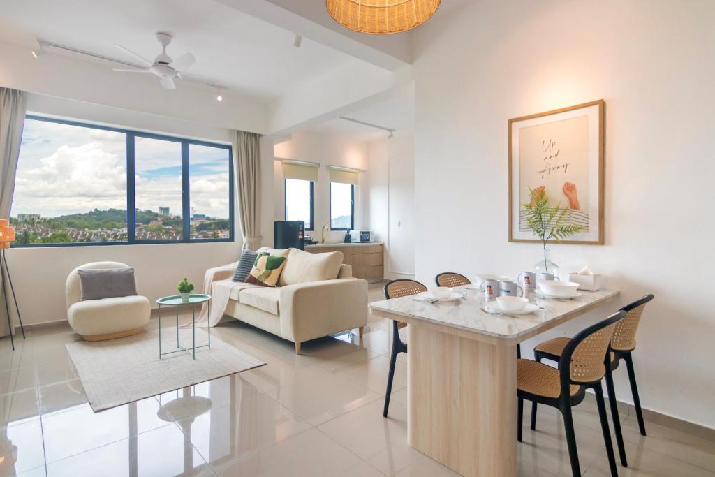 a living room with a table and chairs at Marc CoLiving by Cobytat in Bukit Mertajam