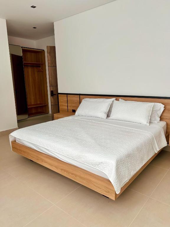 Postel nebo postele na pokoji v ubytování Hotel macana villavicencio