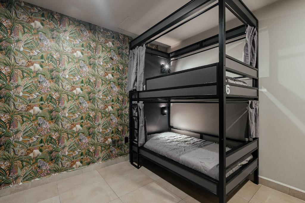 a bedroom with two bunk beds with a floral wallpaper at Bed in mixed room Hippie Nice in Mexico City