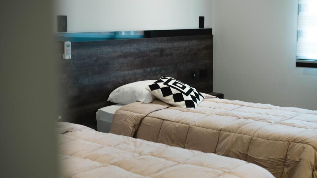 Ένα ή περισσότερα κρεβάτια σε δωμάτιο στο Hotel Alto Center