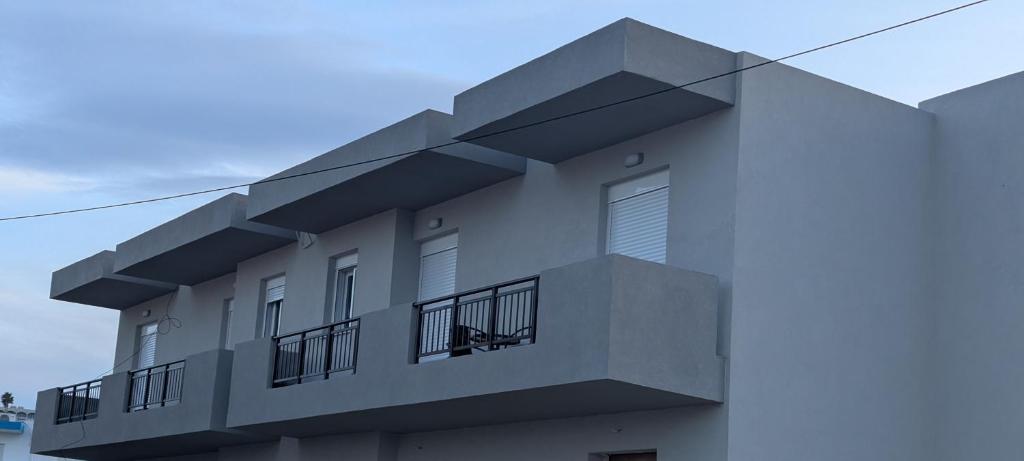 a building with balconies on the side of it at Lilac Kefalos in Kefalos