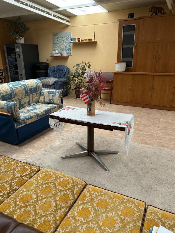 a living room with a table and couches at Pensión Arcano in Arzúa