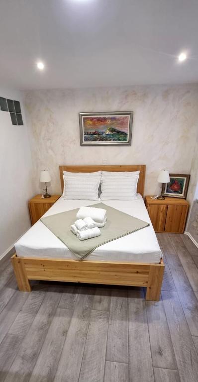 a bedroom with a bed with two towels on it at Lorenzo Old Town in Dubrovnik