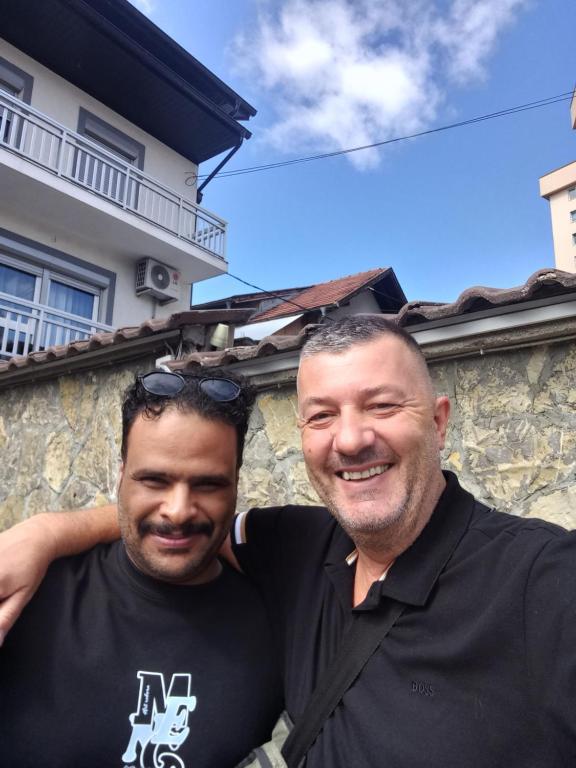 two men standing next to each other in front of a building at Sarajevo apartman Ilidza Springs parking free in Sarajevo