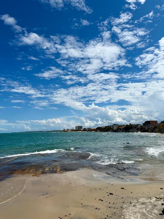 a beach with the ocean and a blue sky with clouds at Suites Prime in Marataizes