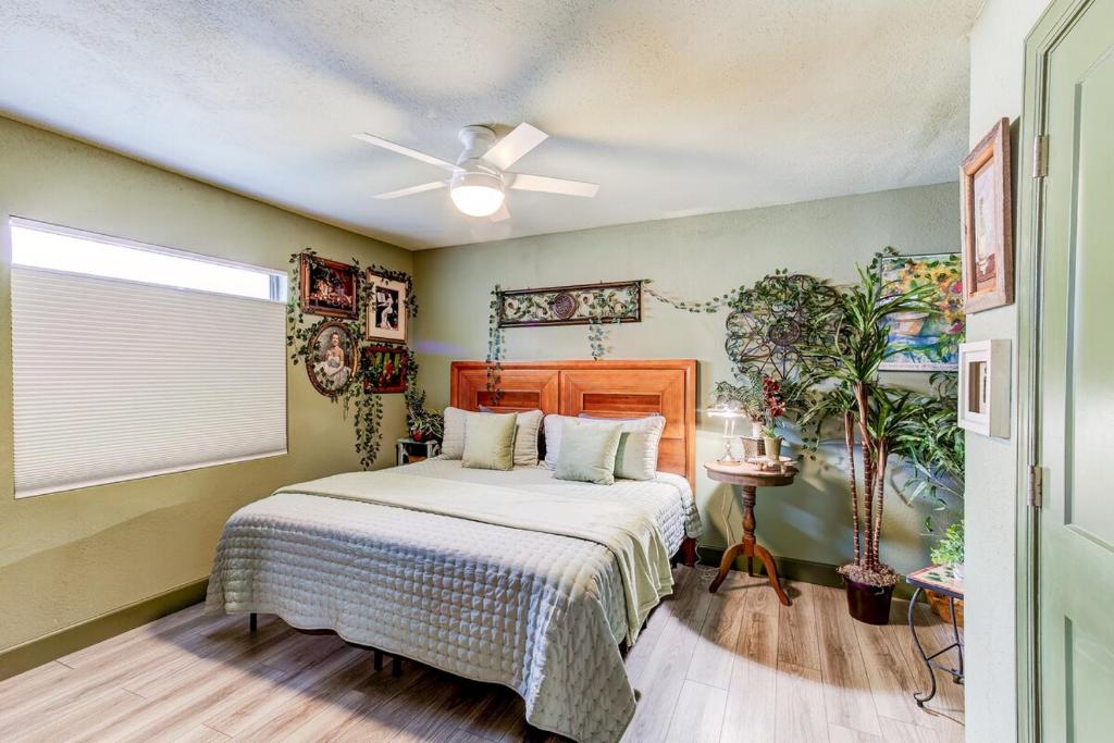 a bedroom with a bed and a ceiling fan at Happy Palette Home Close to downtown Fenced yard in Sanford