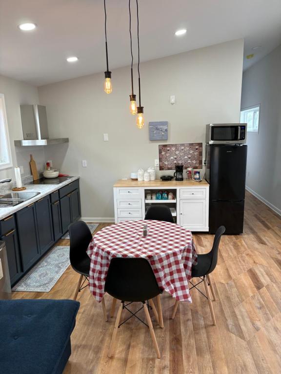 a kitchen with a table and chairs in a kitchen at The Coastal Court Circle Apartment Sports Beach and Shopping in Georgetown