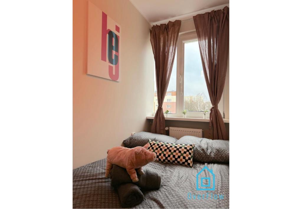 a bedroom with a bed and a window at Piggy Room - 3 km to Baltic Sea in Gdańsk
