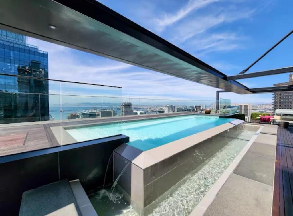 a swimming pool on the roof of a building at Skyline views Stylish Studio with Pool, parking no load shedding in Cape Town