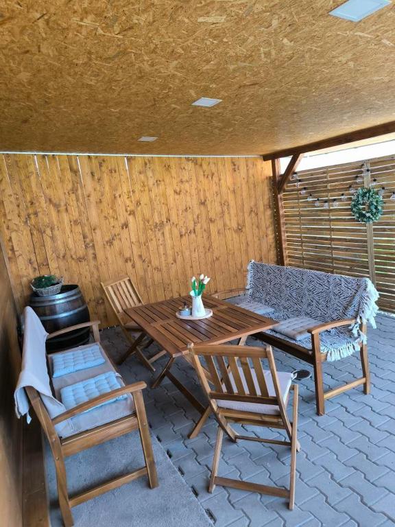 a patio with two chairs and a table and a bench at Sklep Vendelín in Mikulčice