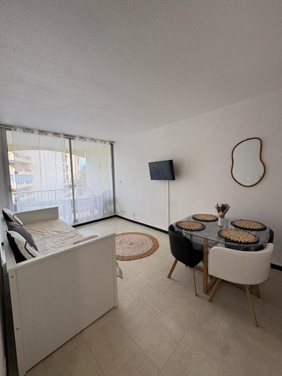 un salon avec un lit, une table et des chaises dans l'établissement Appartement proche de la plage, à Argelès-sur-Mer