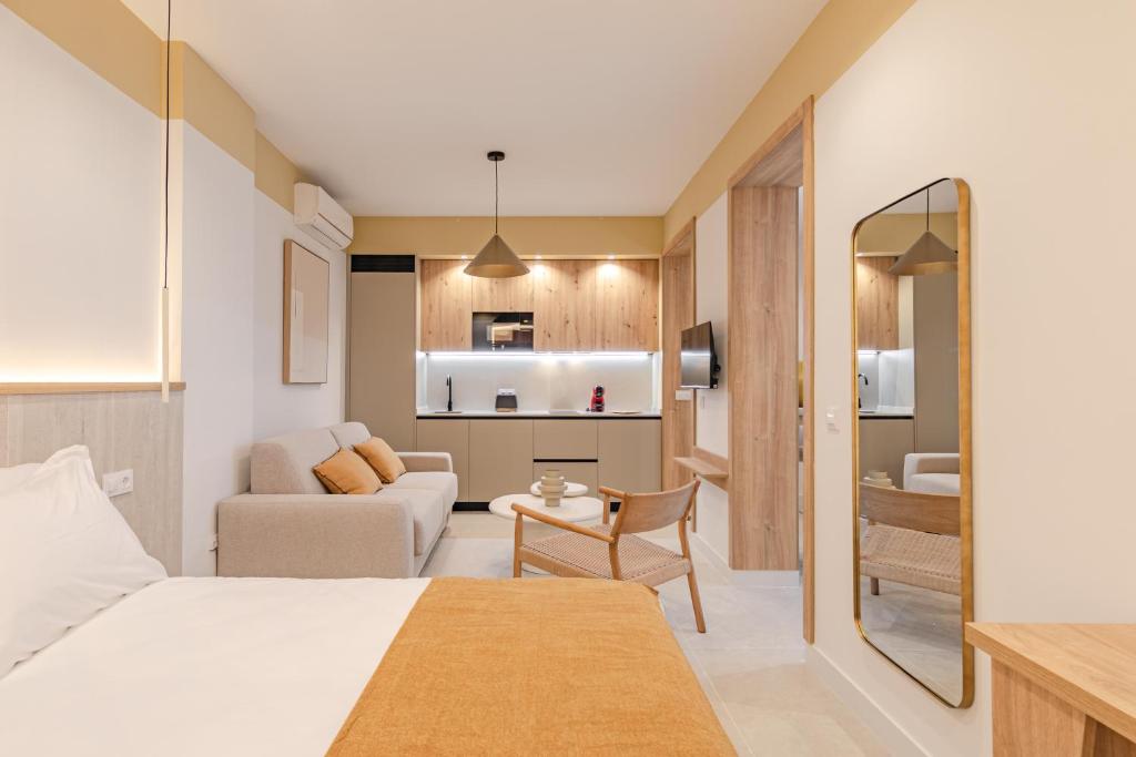 a bedroom with a bed and a living room at Green House in Seville