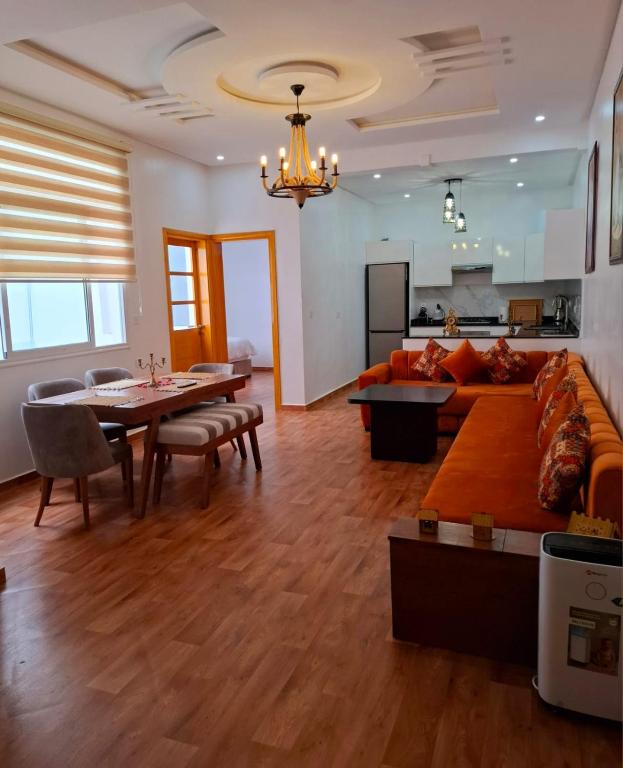 a living room with a couch and a table at Appartement Ghita Essaouira in Essaouira