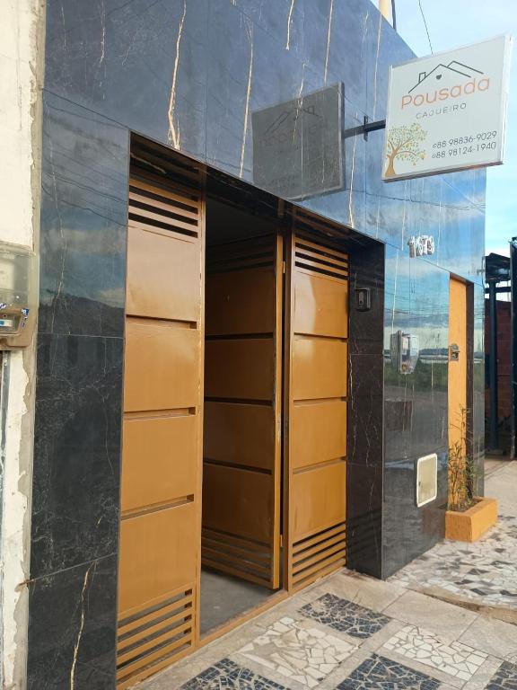a building with three lockers in front of it at Pousada Cajueiro in Juazeiro do Norte