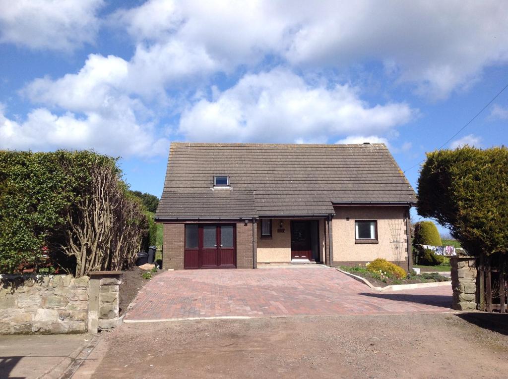 a house with a driveway in front of it at Stow House in Berwick-Upon-Tweed