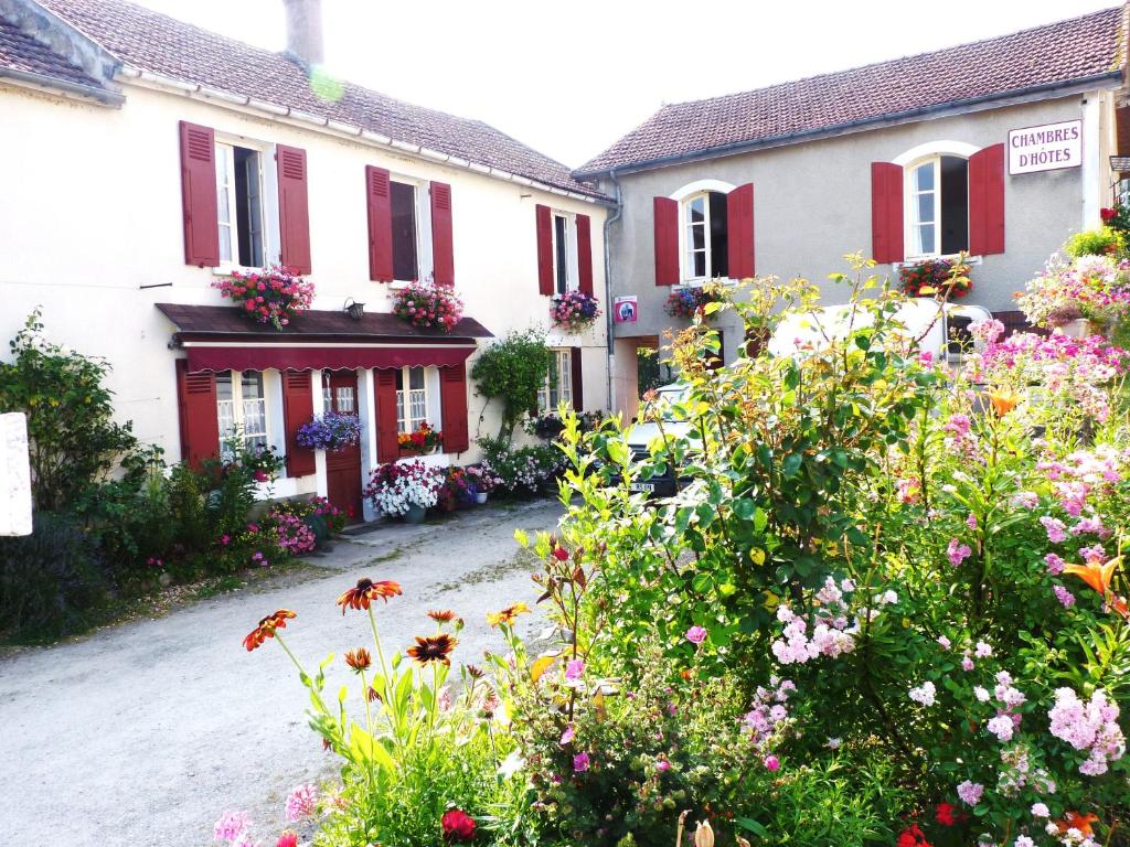 a group of houses with flowers in front of them at La Maison de Cure in Domecy-sur-Cure
