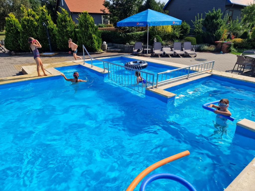 a group of people in a swimming pool at Pensjonat Solis Sarbinowo in Sarbinowo