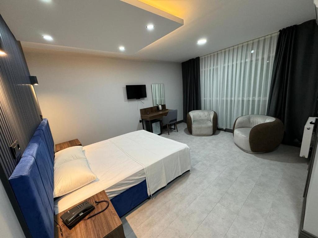 a hotel room with a bed and a desk and chair at Trio Palace in Istanbul