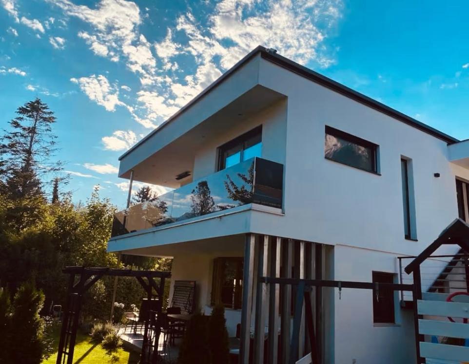 a white house with a balcony on top of it at Inntal Alpin Apartments - Niedere Munde in Telfs