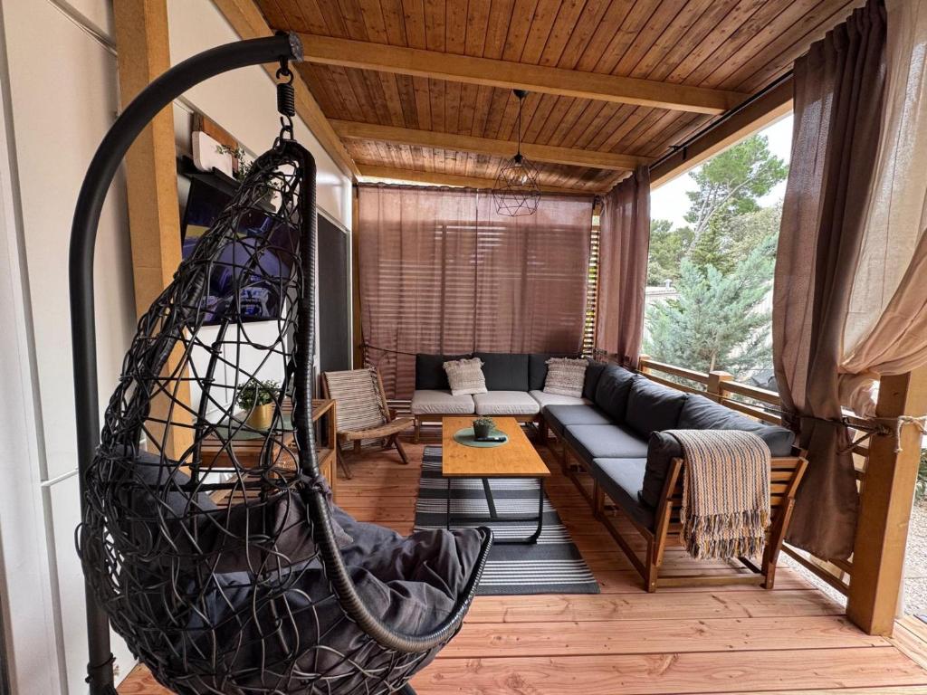 a porch with a hammock in a living room at Ventura mobile home in Biograd na Moru