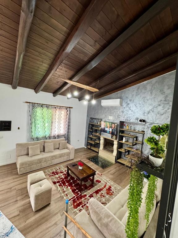 a living room with two couches and a table at Raffaello's Villa in Vlorë