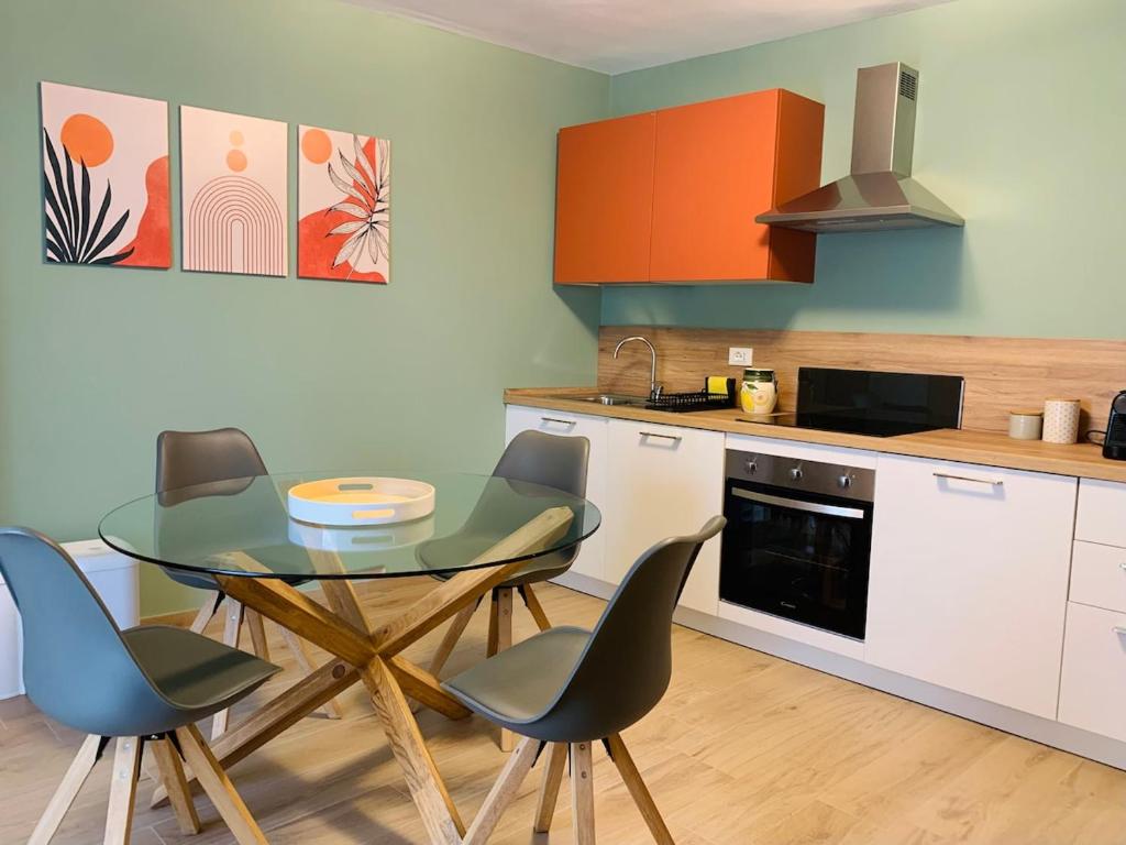 a kitchen with a table and chairs in a kitchen at Ca' dal Pum - Lake Orta - Elegant holiday home in Gozzano
