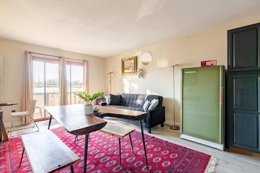 a living room with a table and a couch at 1 BD Boulder Getaway - Pets Allowed with Full Amenities in Boulder