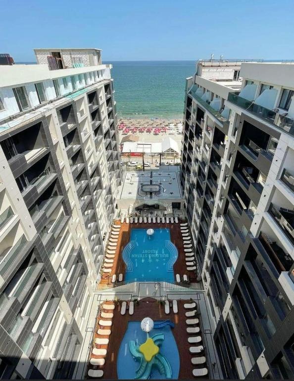 a view of two tall buildings with a pool and the ocean at HF - Mamaia Nord Building Resort in Mamaia Sat/Năvodari