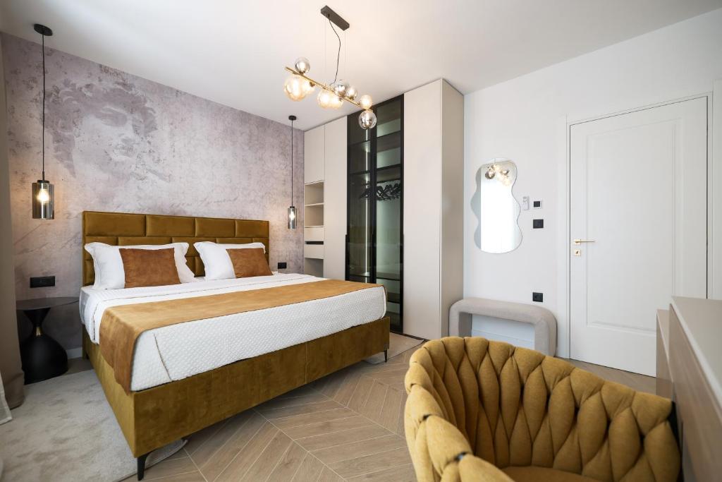 a bedroom with a large bed and a couch at Platea Magna Lux Apartment in Zadar