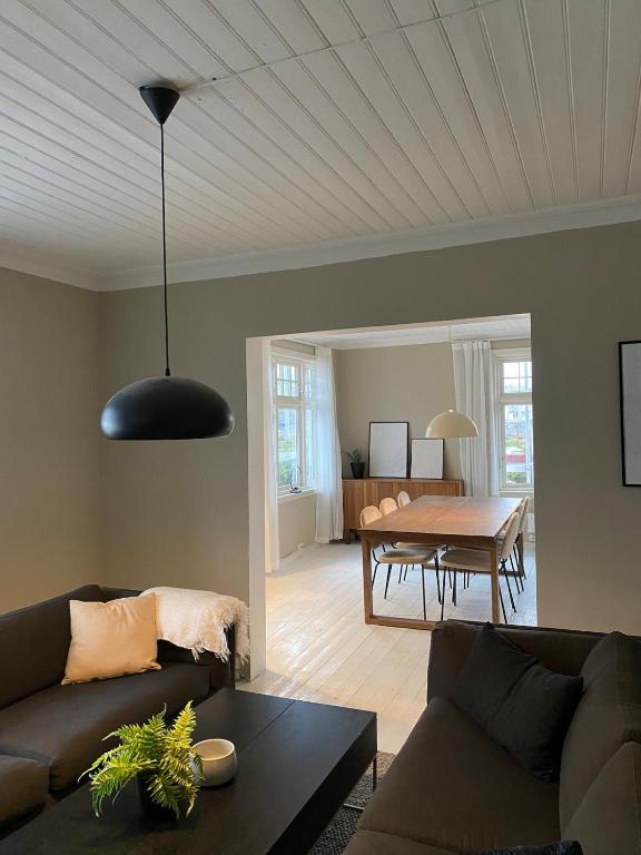 a living room with a couch and a table at Centrally located 6-room detached house in Haugesund