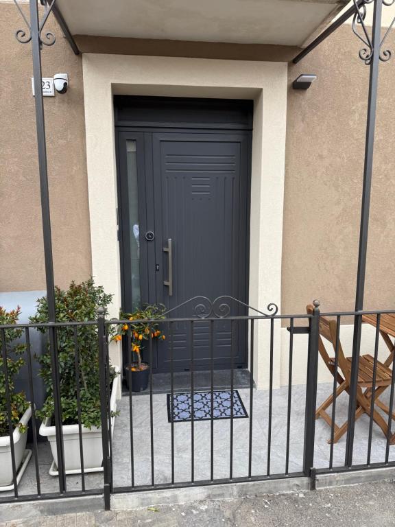 a black front door of a house with plants at La casa di Sesè in Viagrande