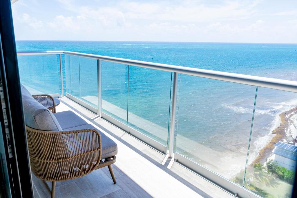 a balcony with a view of the ocean at Distrito Morelos by Andiani Travel in Puerto Morelos