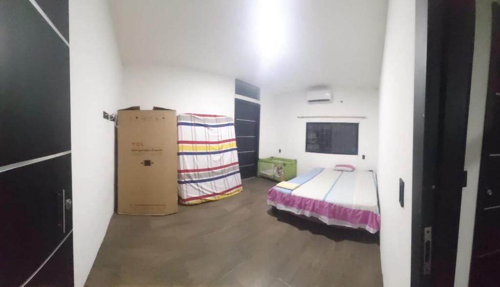 a room with a bed and boxes in it at Casa del Zapallo in Portoviejo