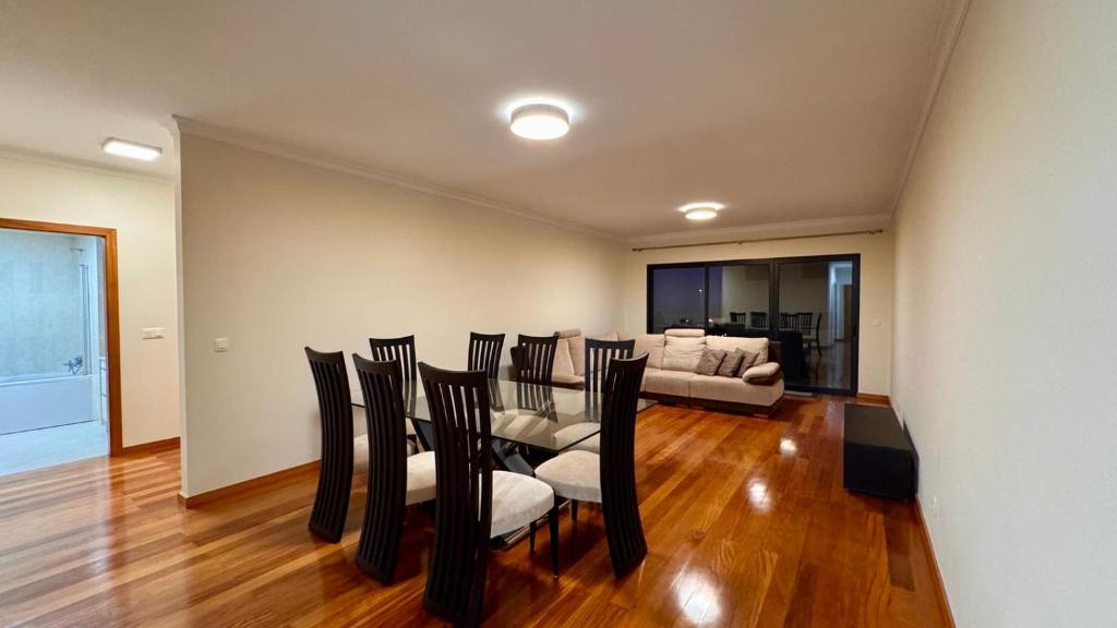 a dining room with a table and chairs and a couch at Coastal Comfort at Riverside - 4 Min to Airport! in Santa Cruz