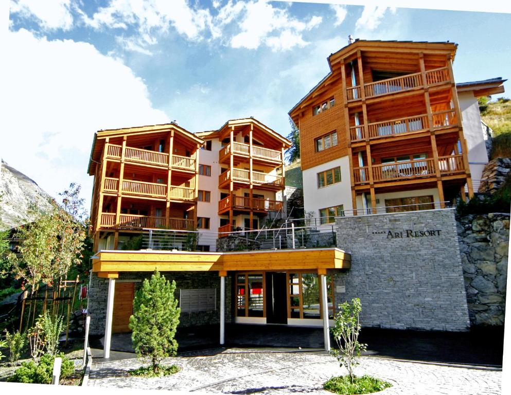 a building with balconies on the side of it at Ari Resort Apartments in Zermatt