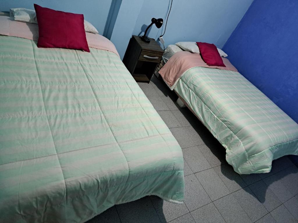 Postel nebo postele na pokoji v ubytování Hostal San Rafael Patagonia