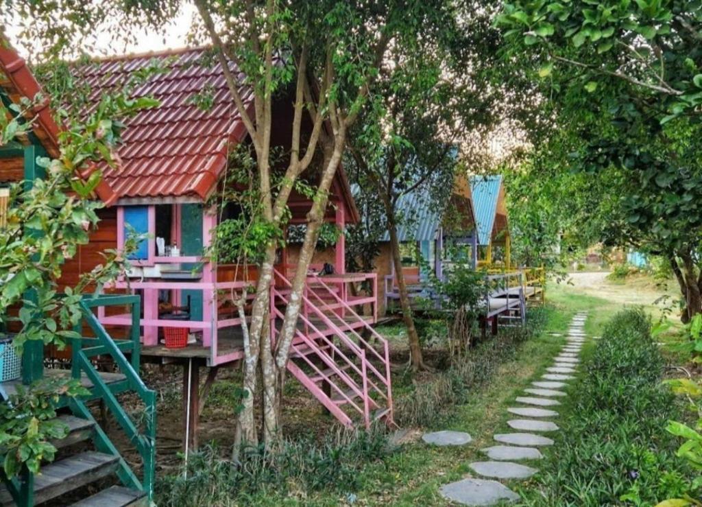a colorful house with a red roof in a forest at Cat Tien Garden Lodge in Cat Tien