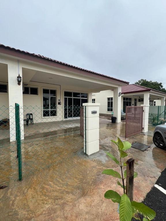 a house with a car parked in front of it at TDH Homestay #5 in Kangar
