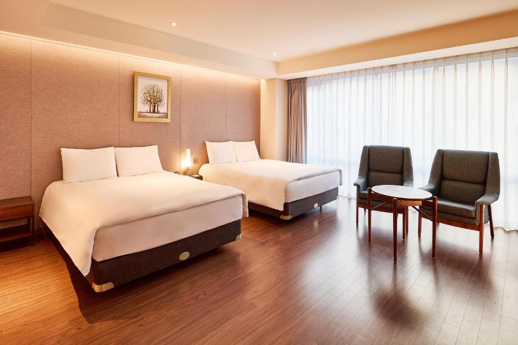 Postel nebo postele na pokoji v ubytování Hotel Thomas Myeongdong