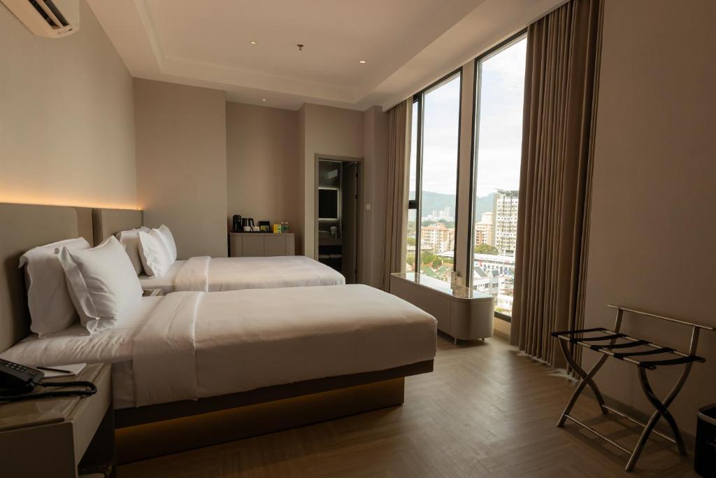 Postel nebo postele na pokoji v ubytování Landison Hotel Penang