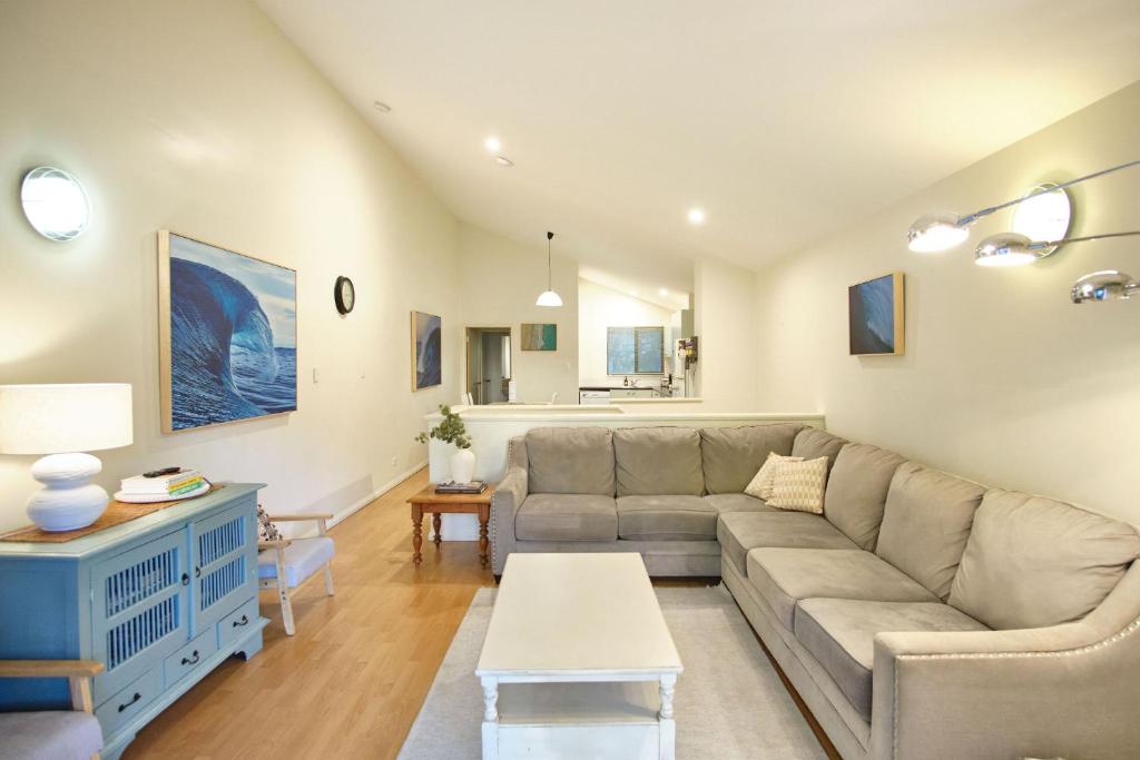 a living room with a couch and a table at Oceanhaus - Margaret River in Margaret River Town
