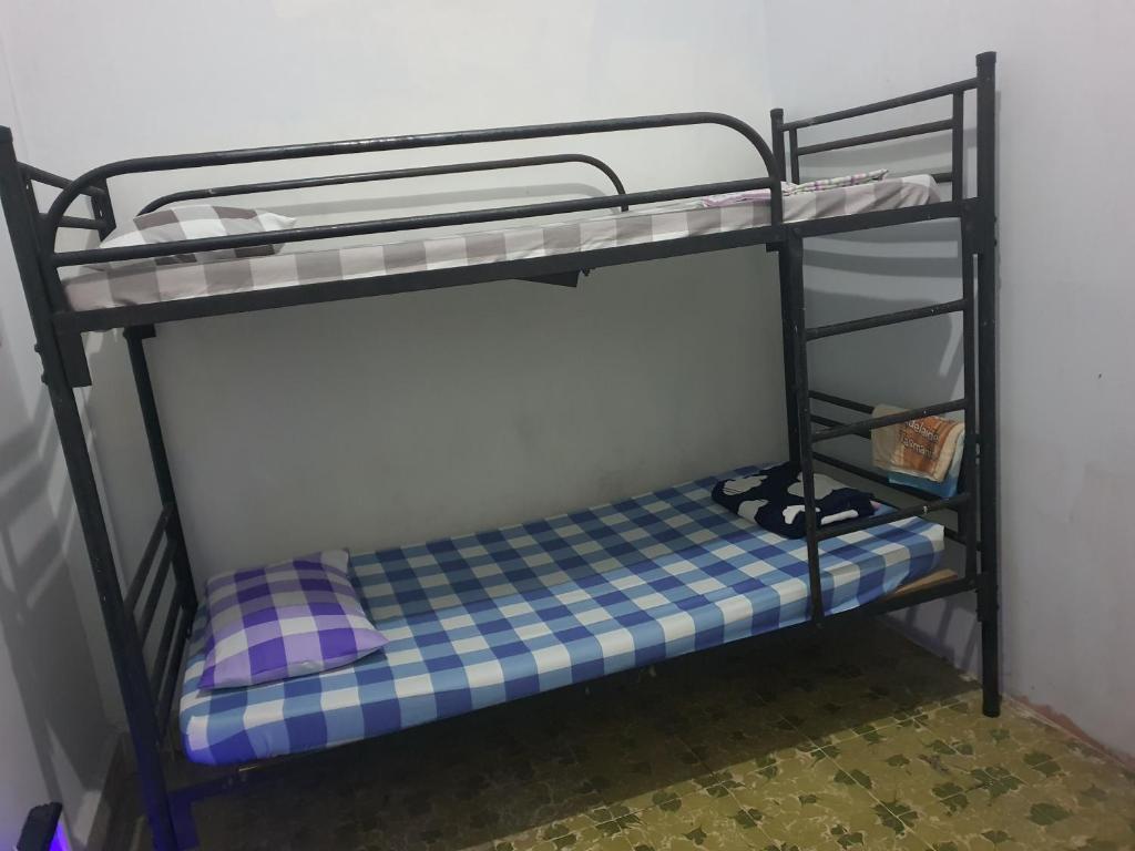 Postel nebo postele na pokoji v ubytování Medan Dazhong Backpacker's Hostel