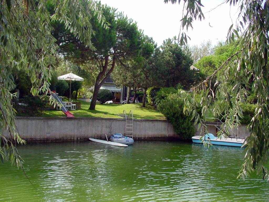a couple of boats sitting in the water at Ottavia in Caleri