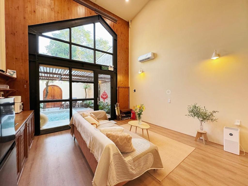 a bedroom with a bed and a large window at Cherish Villa - Near Mountain and Beach - Sơn Trà in Da Nang