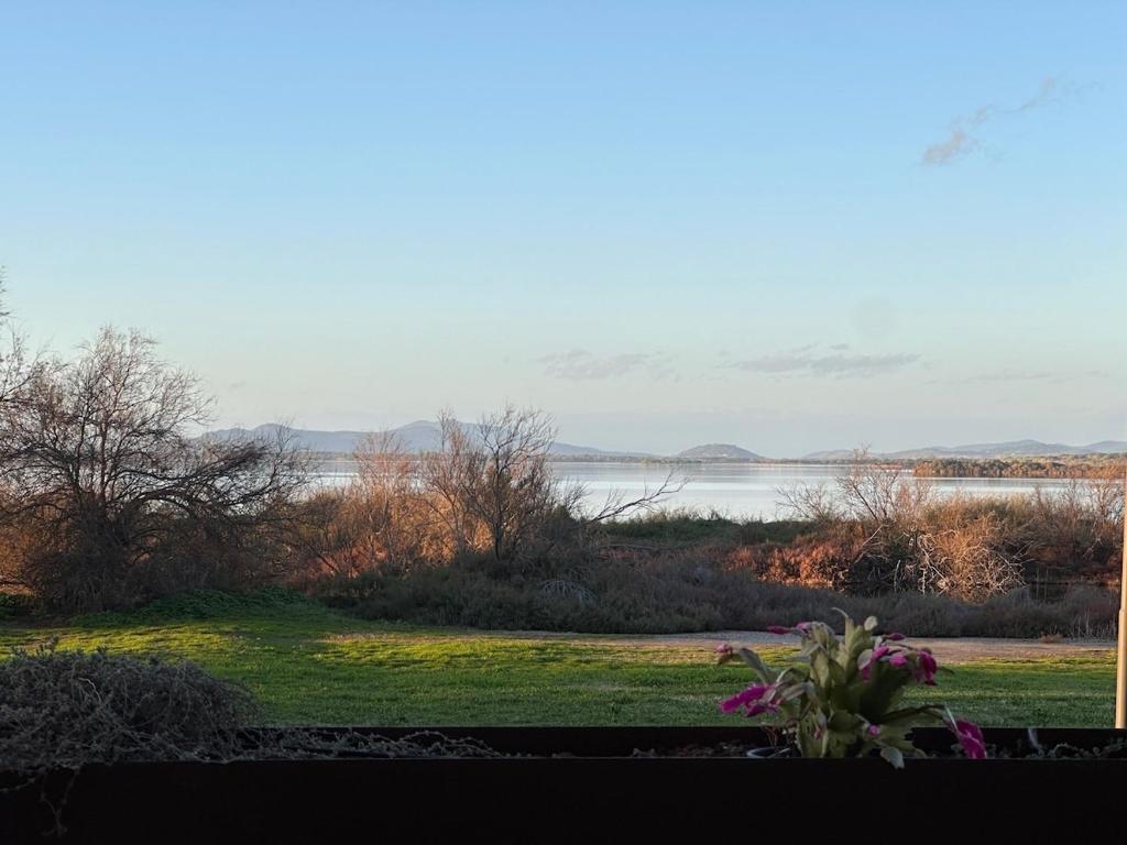 a view of a body of water from a house at Flamingo View apartment in Orbetello