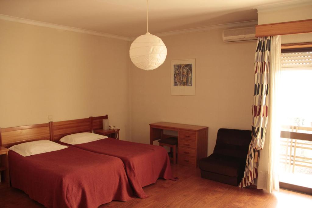 Postel nebo postele na pokoji v ubytování Residencial Dom Manuel
